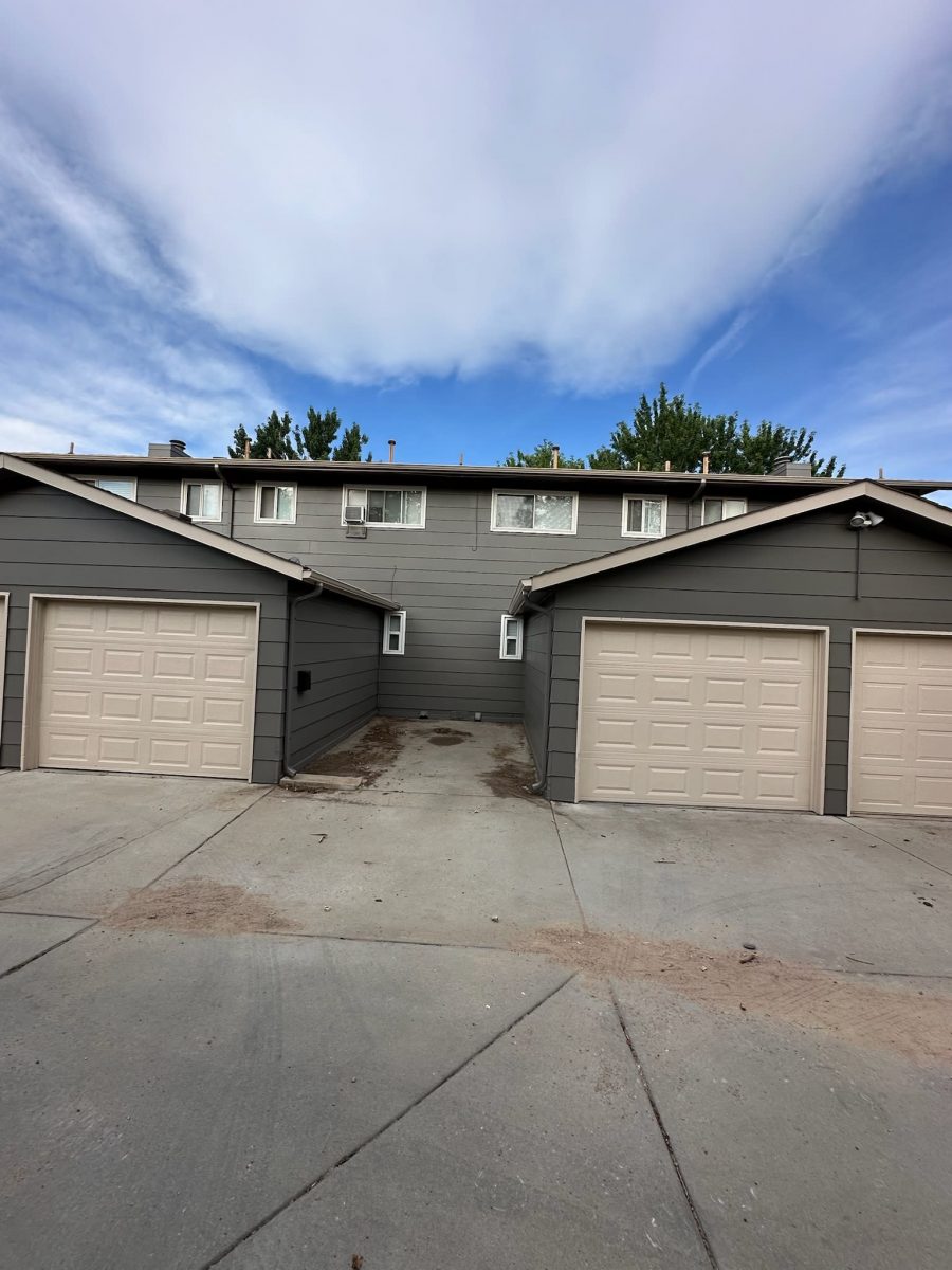 multi-family unit home garages with grey siding and beige doors Preview Image 6