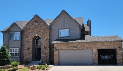 front of house with brick and siding