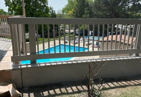 deck railing above in-ground pool