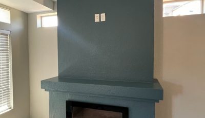 blue painted fireplace and mantle in home