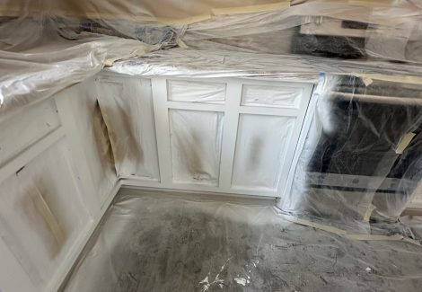 kitchen cabinets with protective coverings during painting