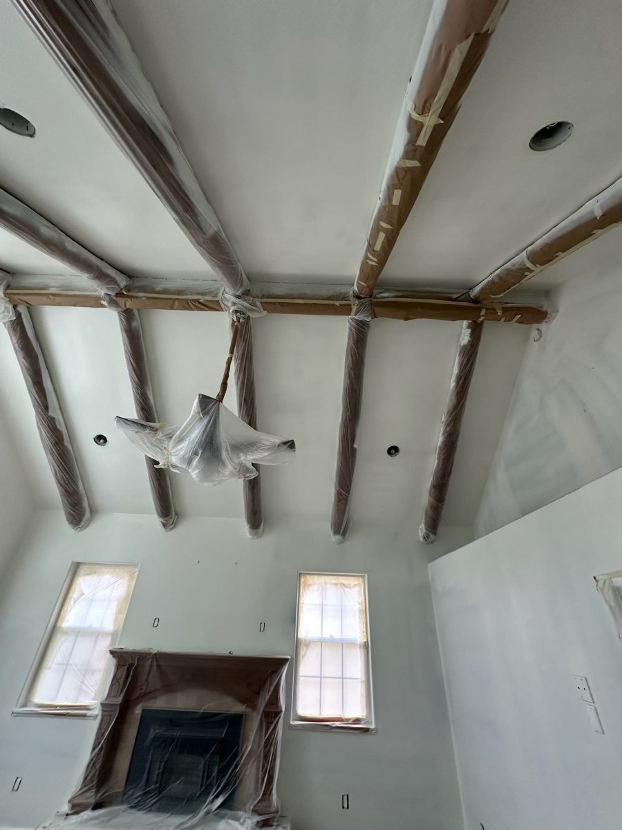 ceiling beams and fan with protective plastic during paint project Preview Image 2