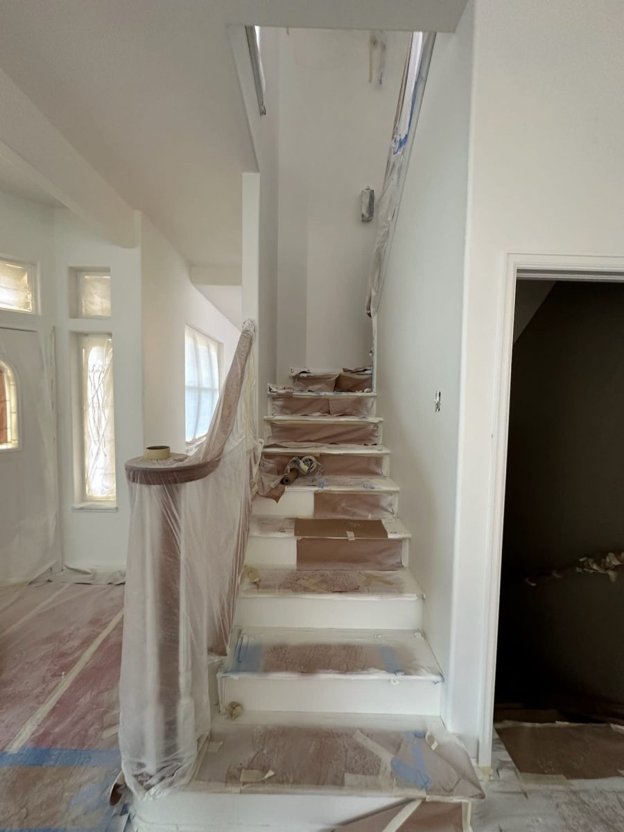 home staircase with protective plastic during paint project Preview Image 3