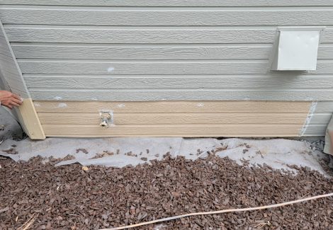 siding with replaced boards before painting