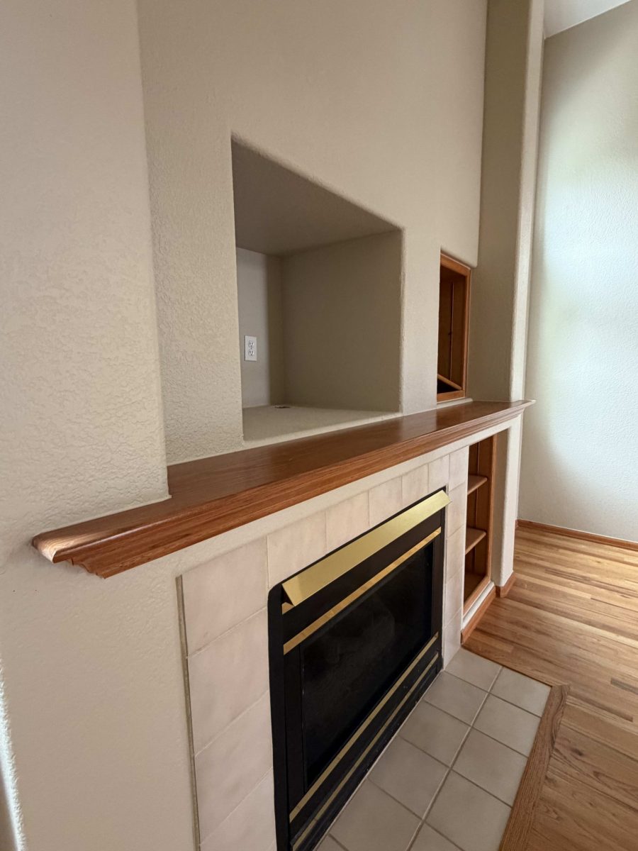 white painted wall surrounding fireplace and stained wood mantle Preview Image 3