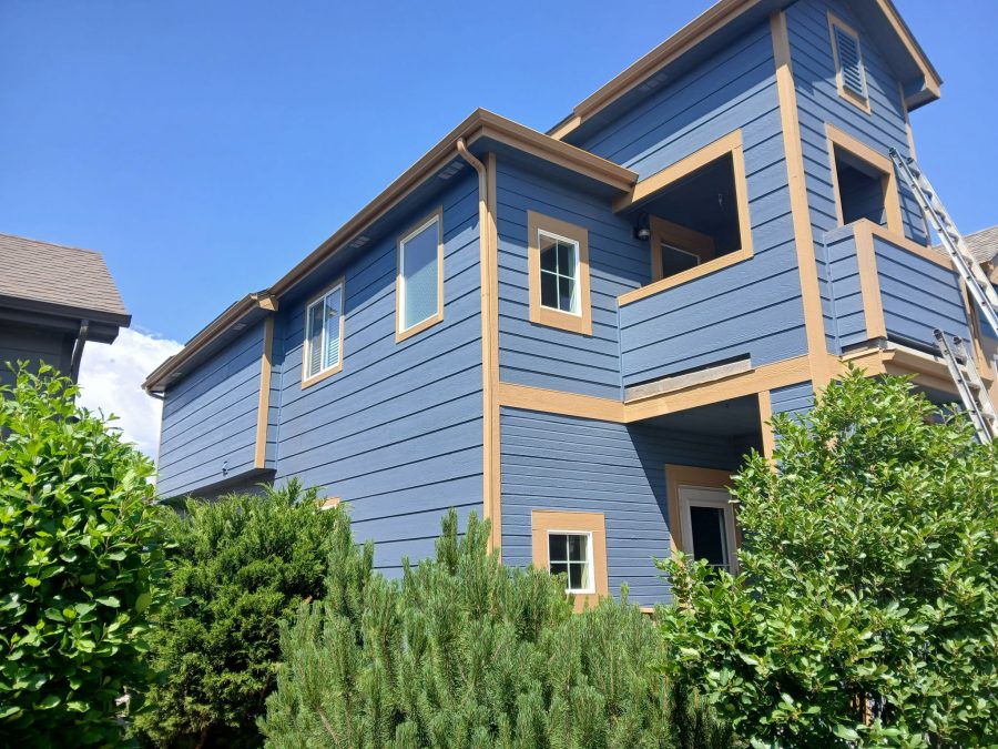 side view of house exterior with blue siding and tan trim Preview Image 3