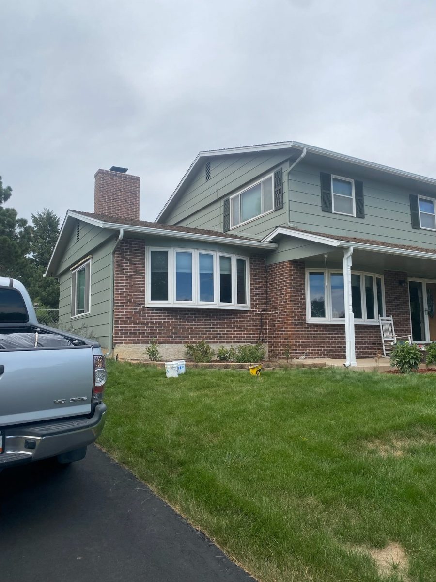 front of house with brick and green siding Preview Image 2
