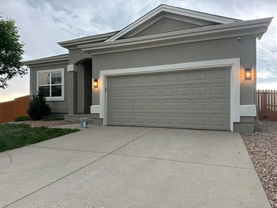 driveway and garage of stucco home