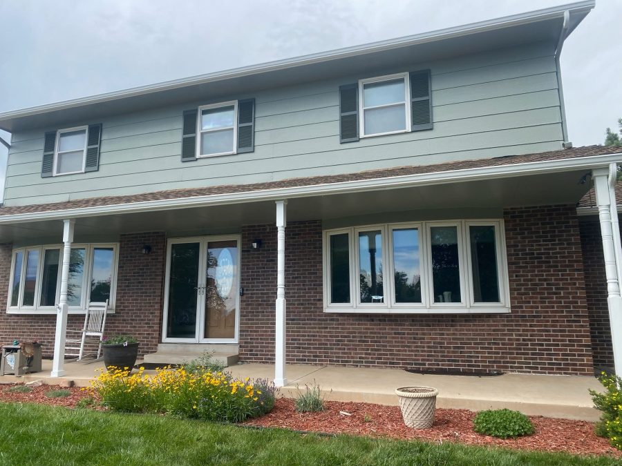 front of house with brick and green siding Preview Image 1