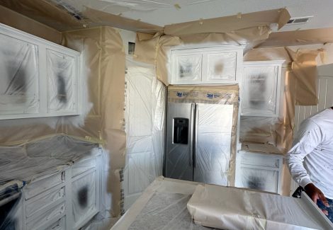 kitchen cabinets with protective coverings during painting