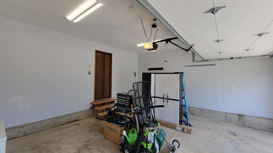 home garage with items gathered in center of room
