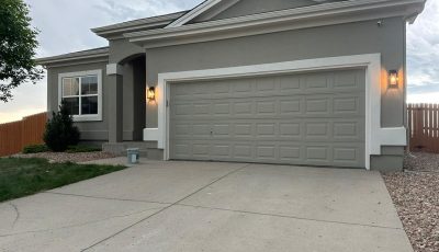 driveway and garage of stucco home