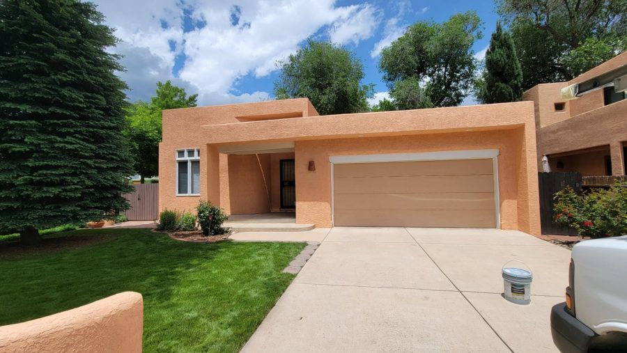 front of painted stucco house with driveway and garage door Preview Image 1