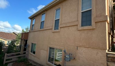 side of home with repainted stucco