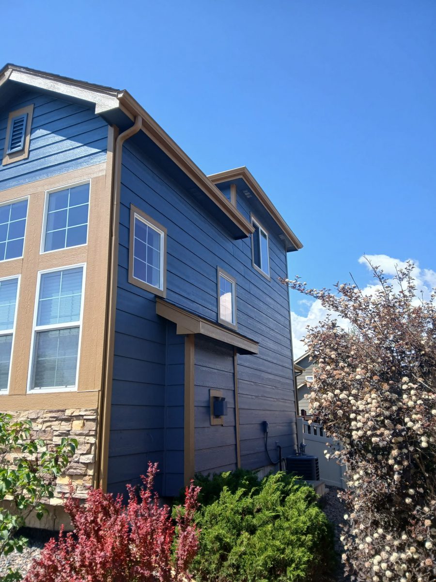 corner view of house exterior with blue siding and tan trim Preview Image 2