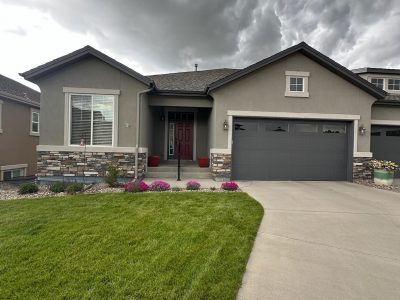 front door and garage of painted twin house with driveways