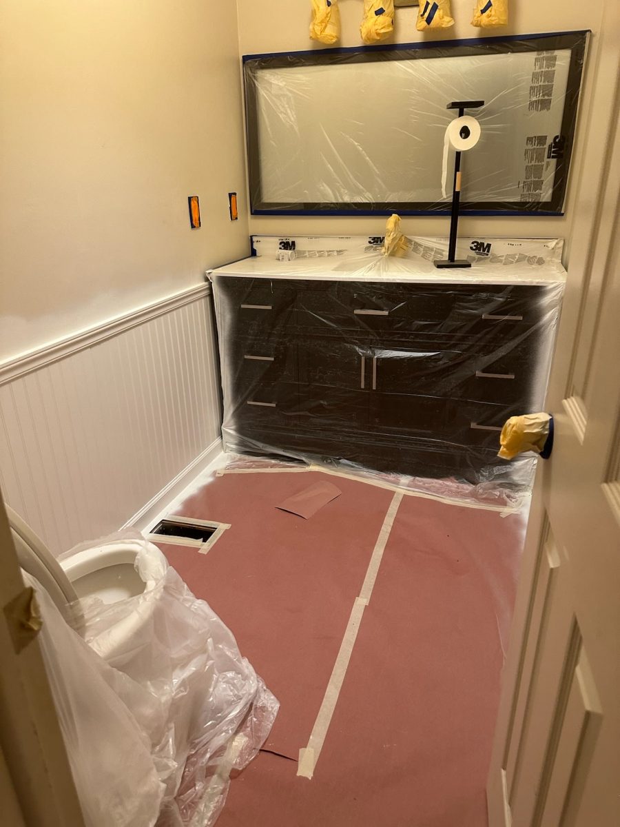 home bathroom with protective coverings for a paint project