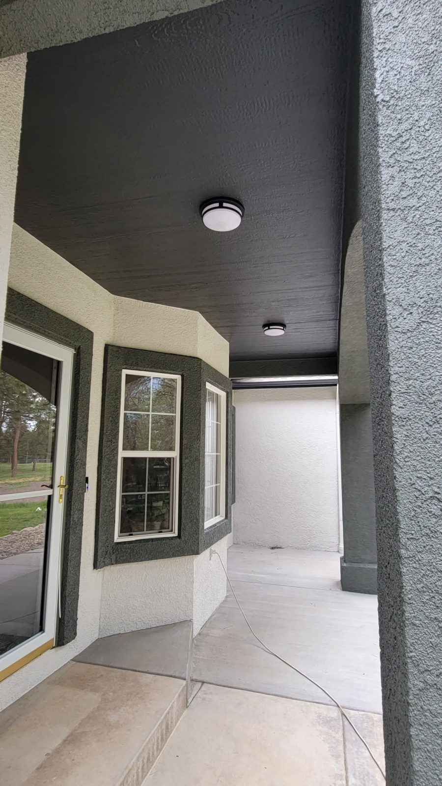 two tone painted stucco covered front porch