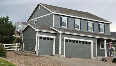 home with grey painted siding and blue shutters