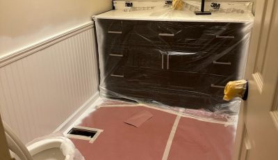 home bathroom with protective coverings for a paint project