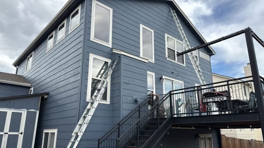 ladder leaning against house with blue siding Preview Image 1