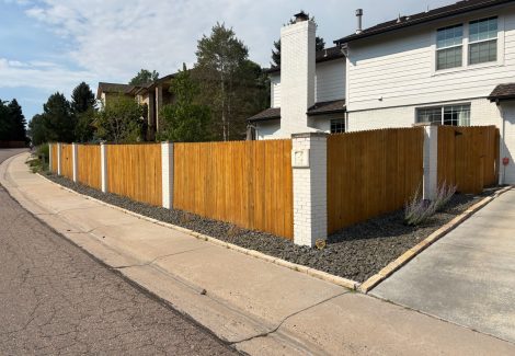 stained wooden fence surrounding home