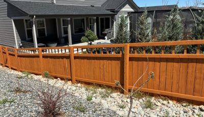 stained fence surrounding house