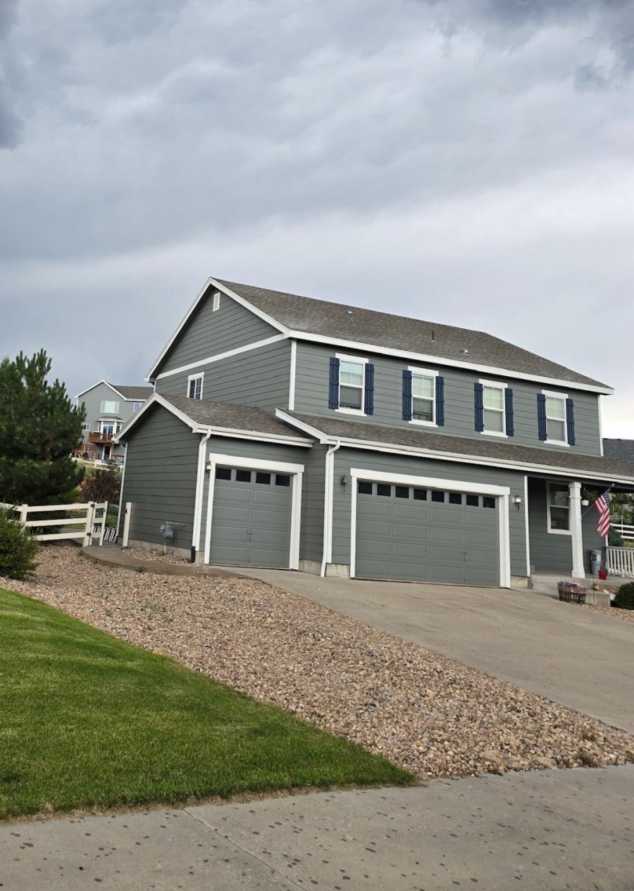 home with grey painted siding and blue shutters