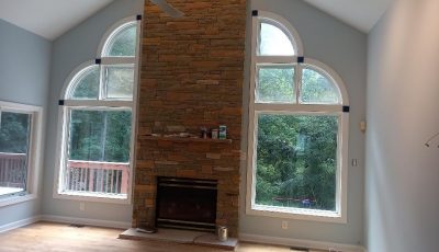 This room was painted a grey color that highlights the natural light of the space.