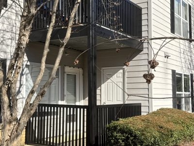 exterior of condo building with black painted balcony railings