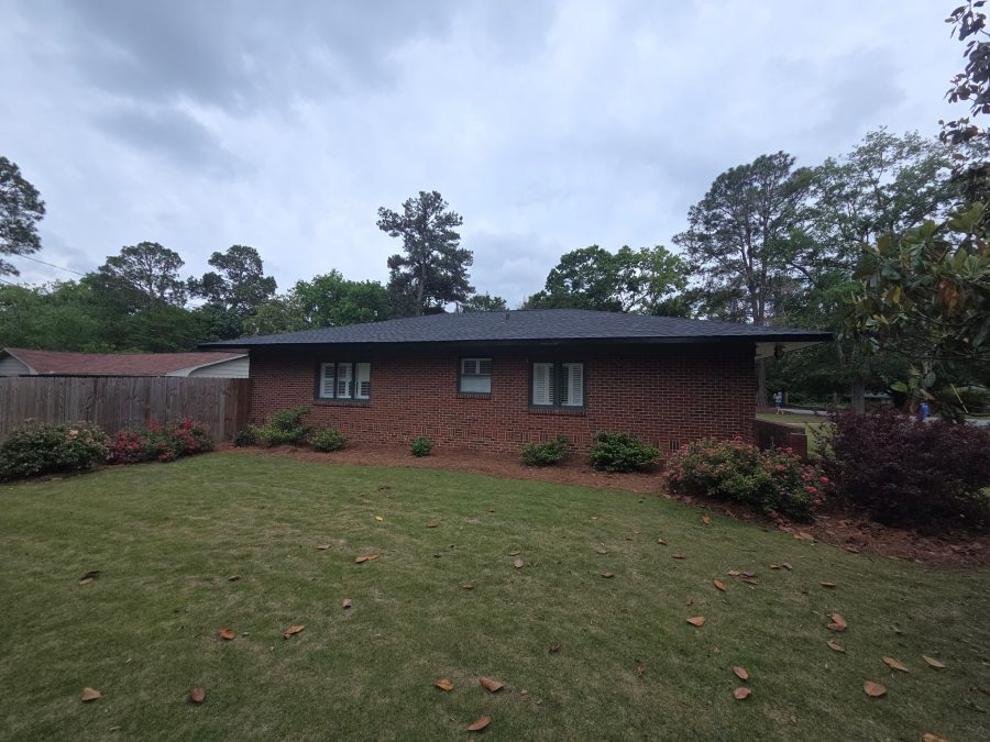 brick house with dark green painted siding and accents Preview Image 1