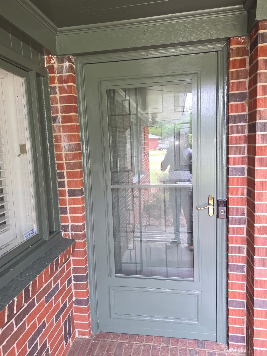 brick home exterior with dark green painted door and trim Preview Image 2