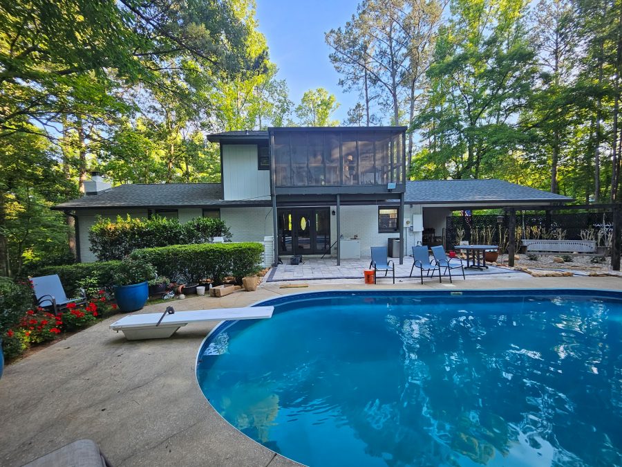 rear side of painted home with back yard and inground pool Preview Image 3