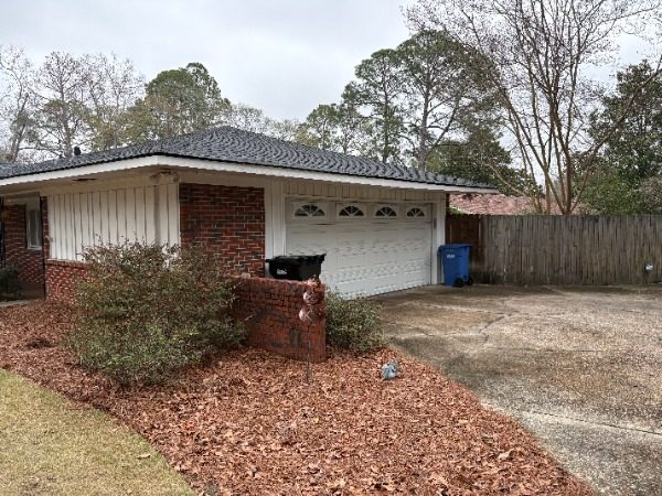 brick house exterior with white siding and garage door Preview Image 6