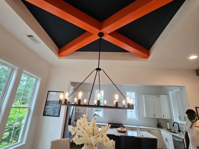 room with coffered ceiling painted orange and black
