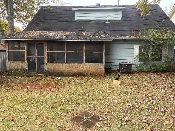 rear of house exterior with worn white siding Preview Image 5