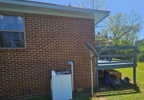 blue stained wooden deck on brick house