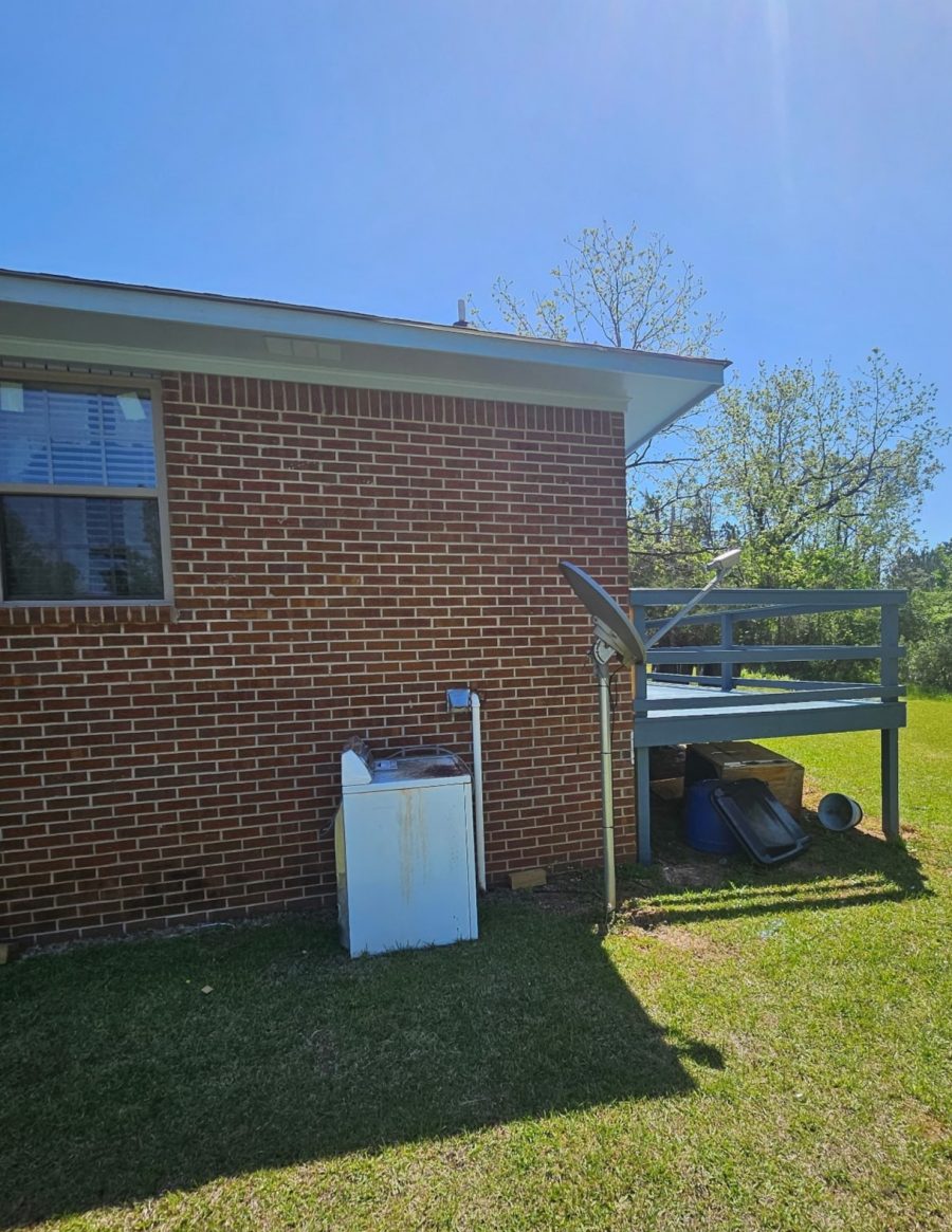 blue stained wooden deck on brick house Preview Image 2