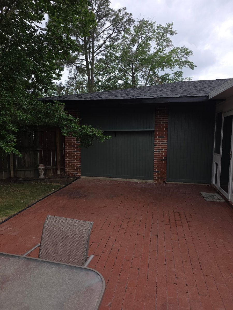 brick house with dark green painted siding and garage door Preview Image 4