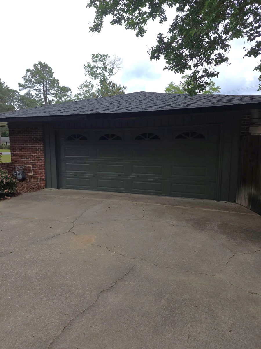 brick house with dark green painted siding and garage door Preview Image 5