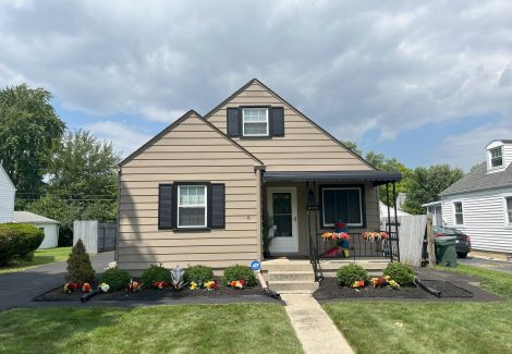 house with beige siding and black trim