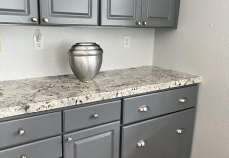 Kitchen cabinets repainted gray.