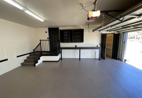 garage interior with black painted cabinets and accents