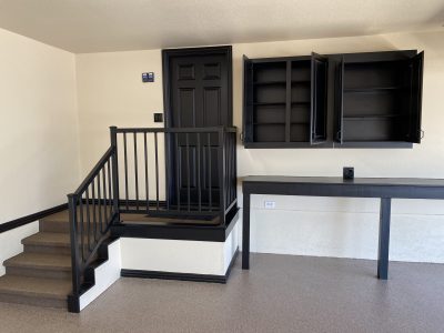 garage interior with black painted cabinets and accents