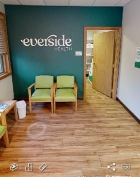 waiting room of doctors office with signage on a green wall Preview Image 4