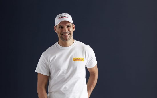 CertaPro Team Member smiling for the camera in front of a black backdrop