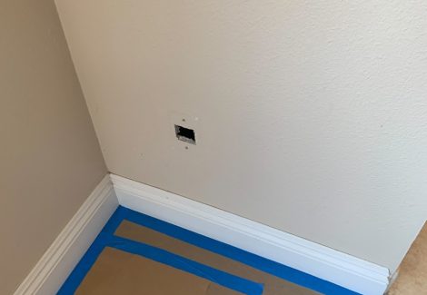 Protecting the floor before painting the walls.