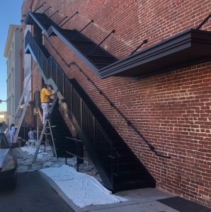 Painting the stairs of the Bijou Theater