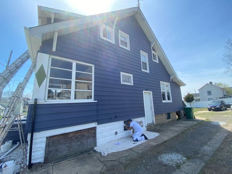 Side View of Exterior Paint dark blue and white trim Preview Image 1