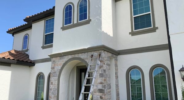 house exterior painted white with brown trim by certapro painters of east orlando